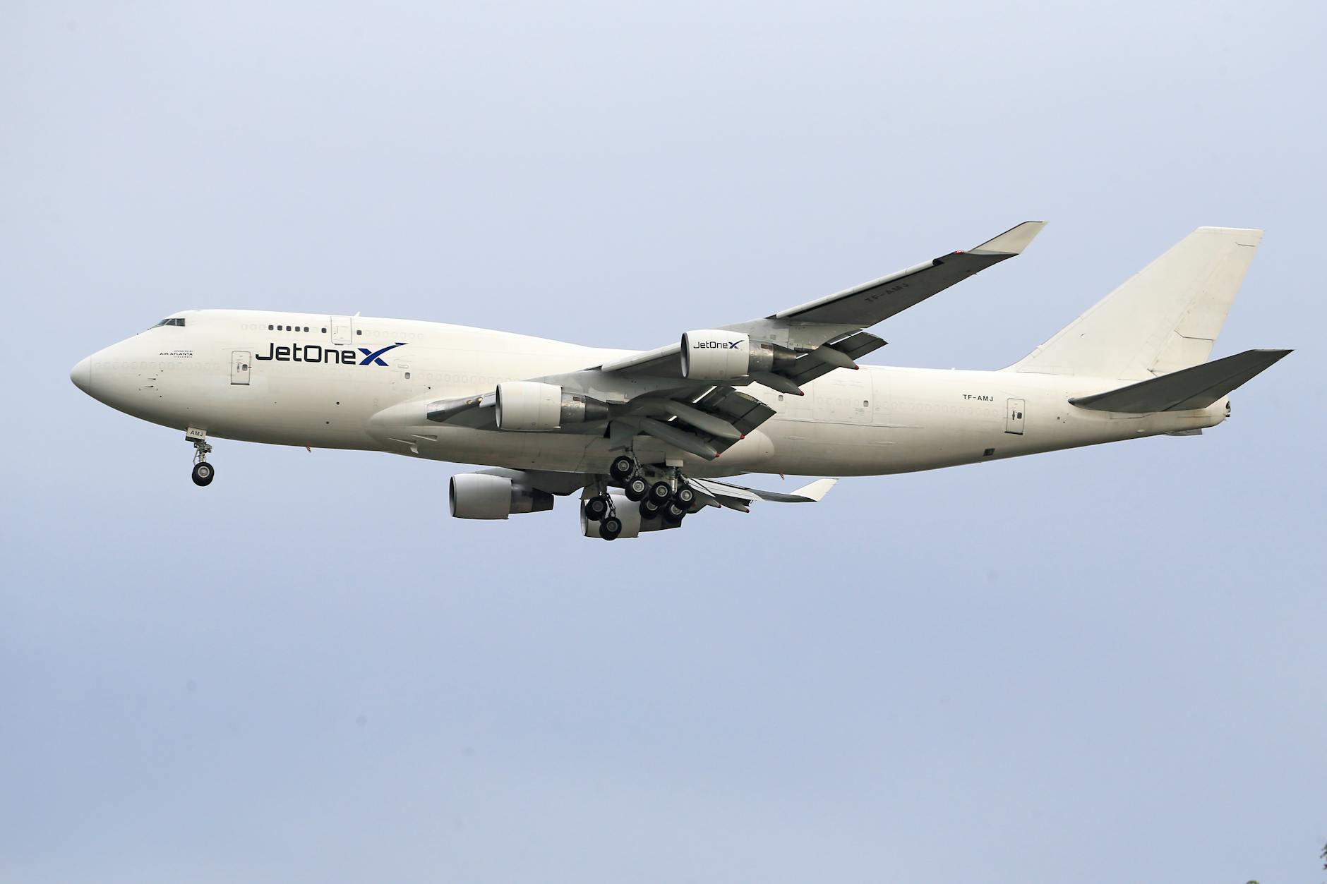 A commercial jet from JetOneX captured in flight, highlighting aviation travel.