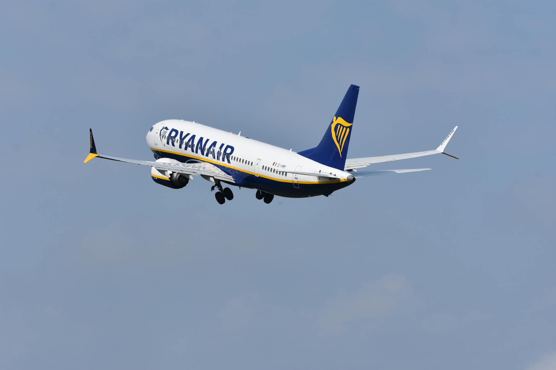 A Ryanair aircraft soaring through a clear blue sky, capturing the essence of modern air travel.