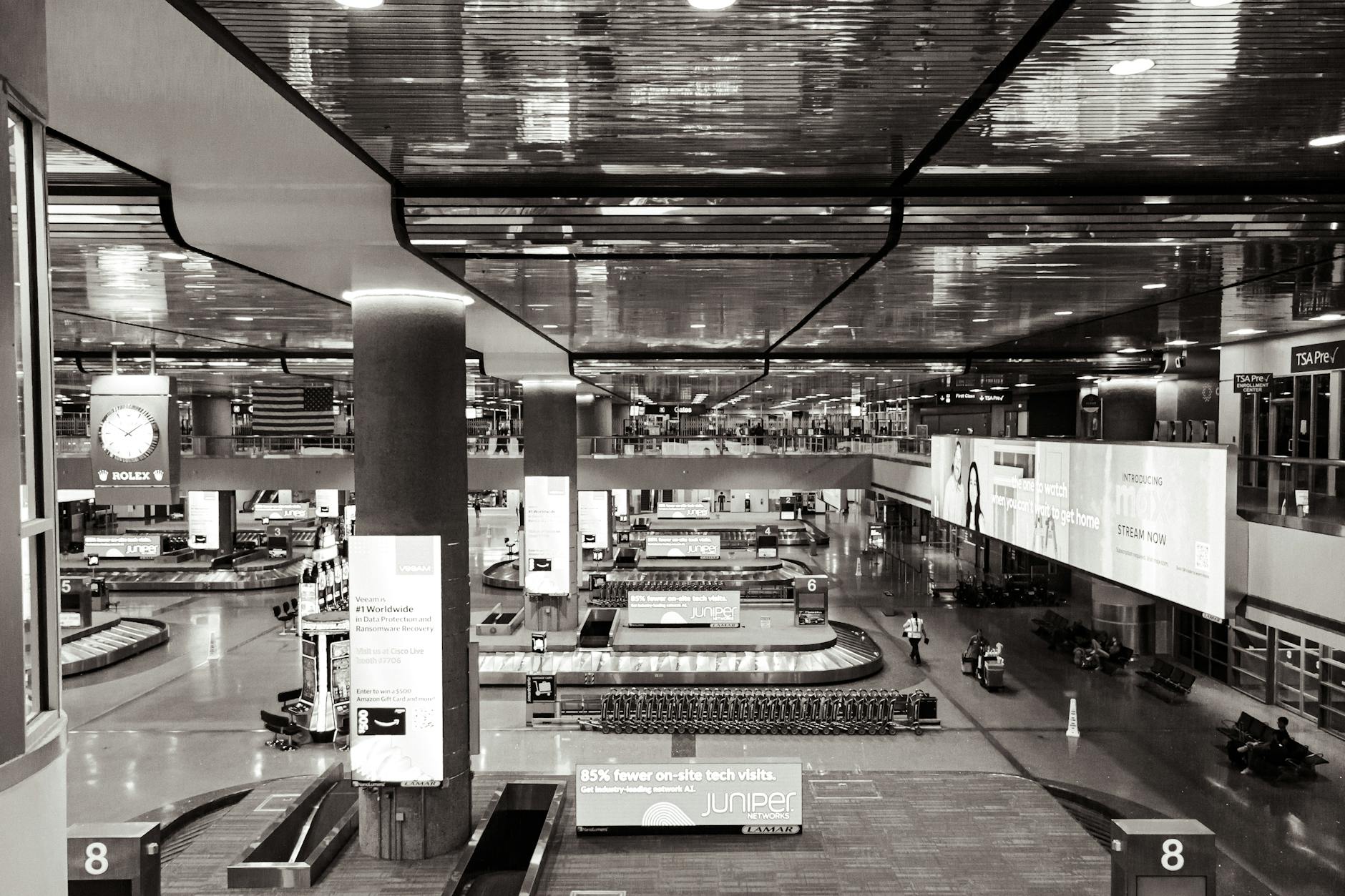 Monochrome view of a spacious, modern airport terminal in Las Vegas.