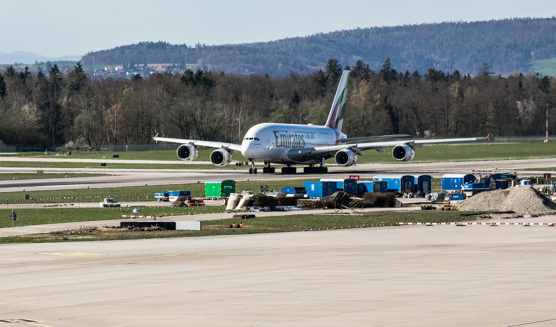 Emirates Airbus A380 preparing for takeoff at Zurich Airport on a clear day.