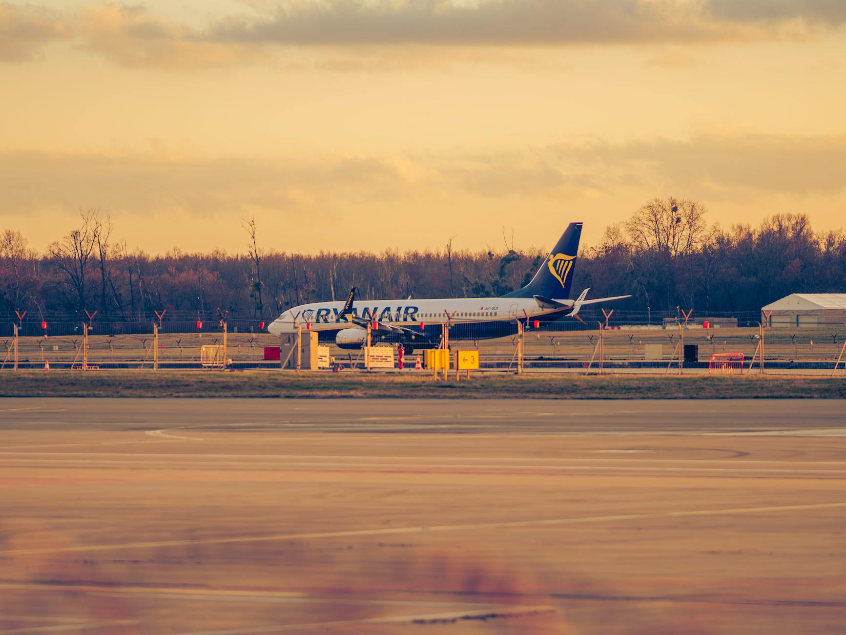 Ryanair aircraft parked at Wroclaw Airport under a beautiful sunset sky, Lower Silesia, Poland.