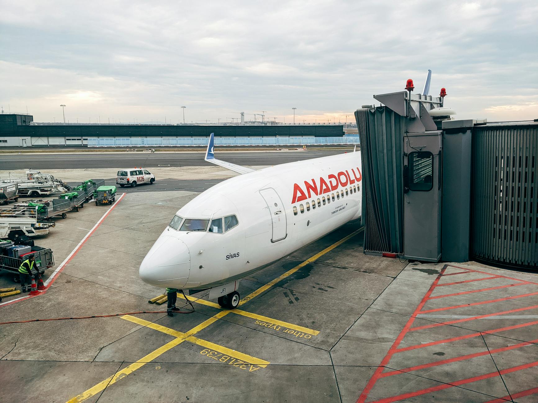 Anadolu Jet airplane docked at a gate in Frankfurt Airport during daylight.