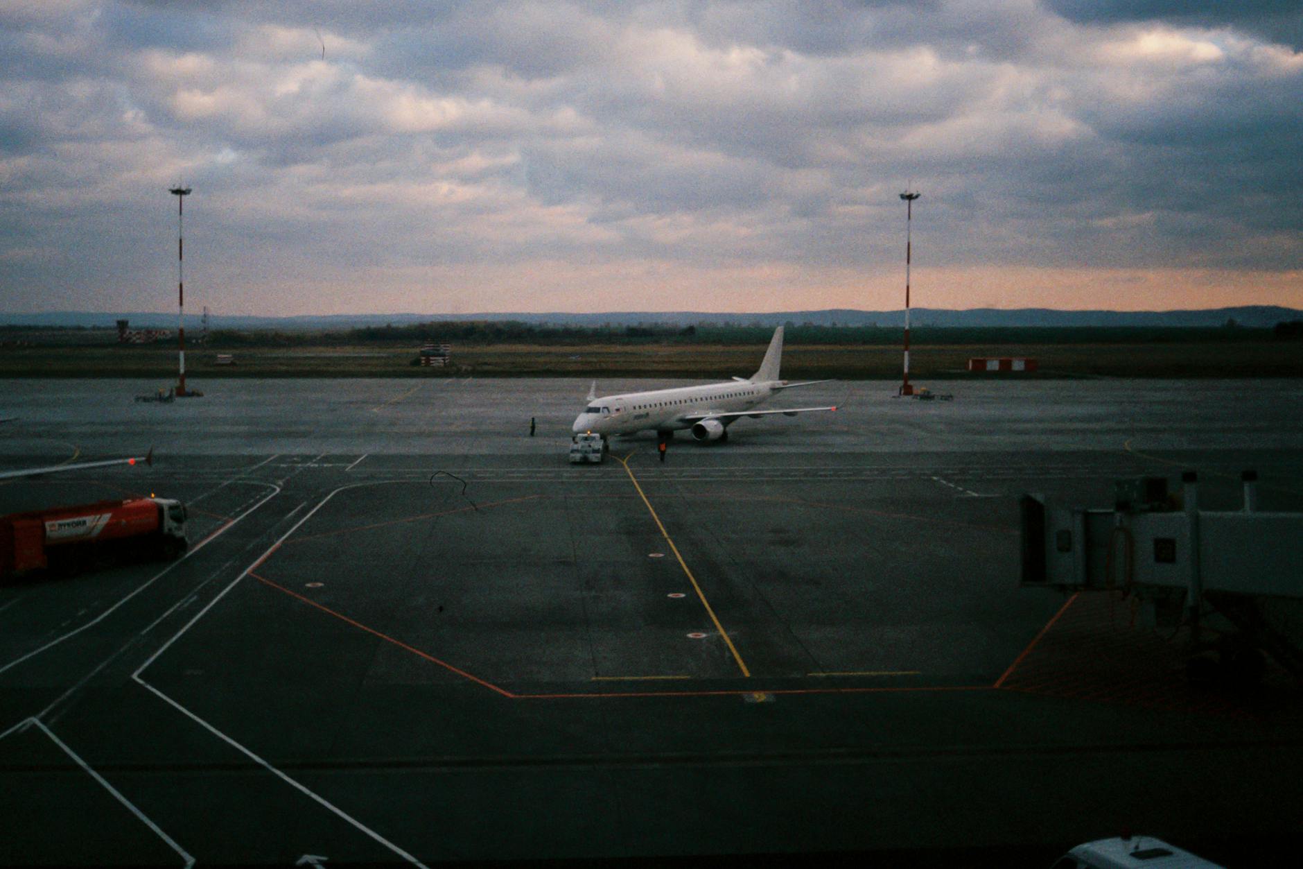 A commercial airplane on a tarmac at dusk, showcasing aviation and travel setting.
