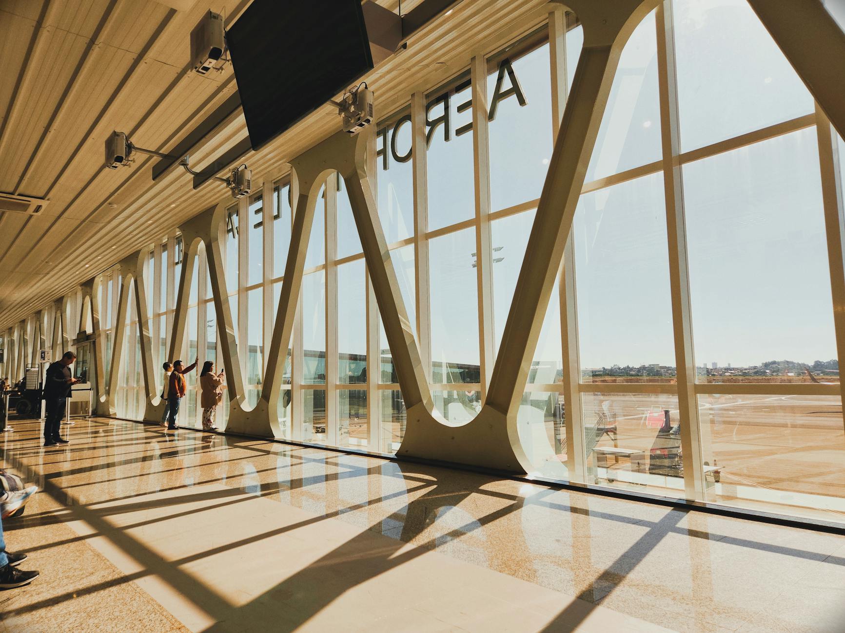 Interior view of a sunlit airport terminal in Cascavel, Brazil, showcasing modern architecture.