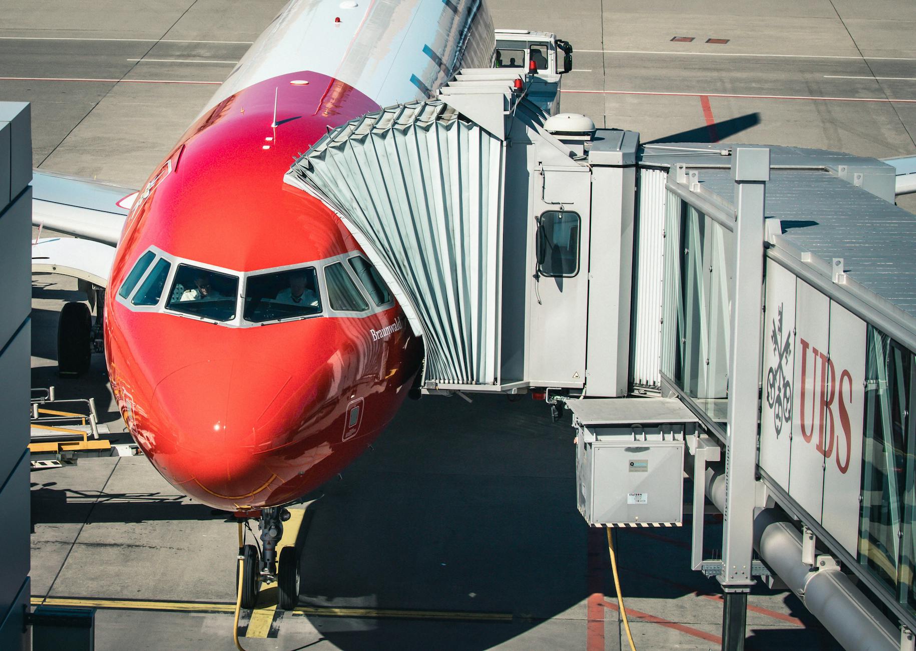 Airplane connected to jet bridge at Zurich Airport, Switzerland, ready for passengers.