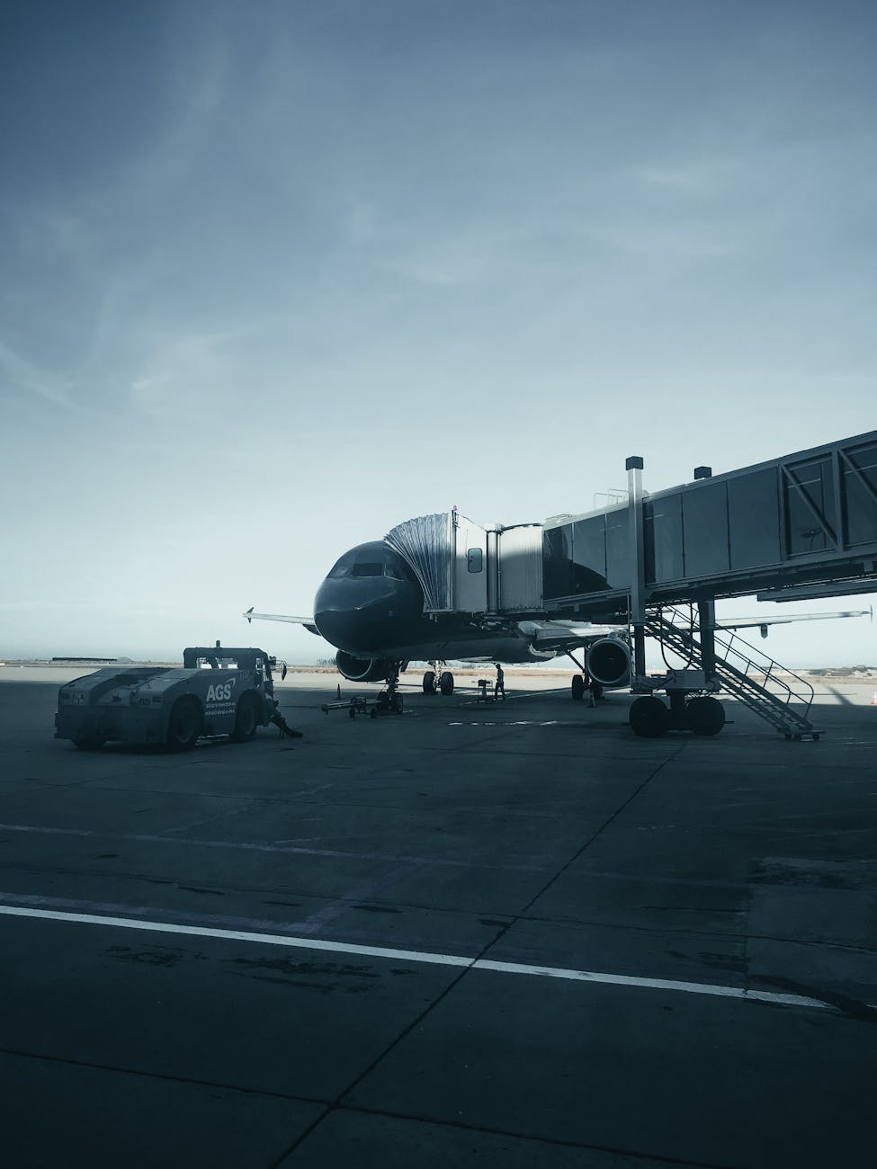 Commercial airplane connected to jet bridge at Cam Ranh airport.