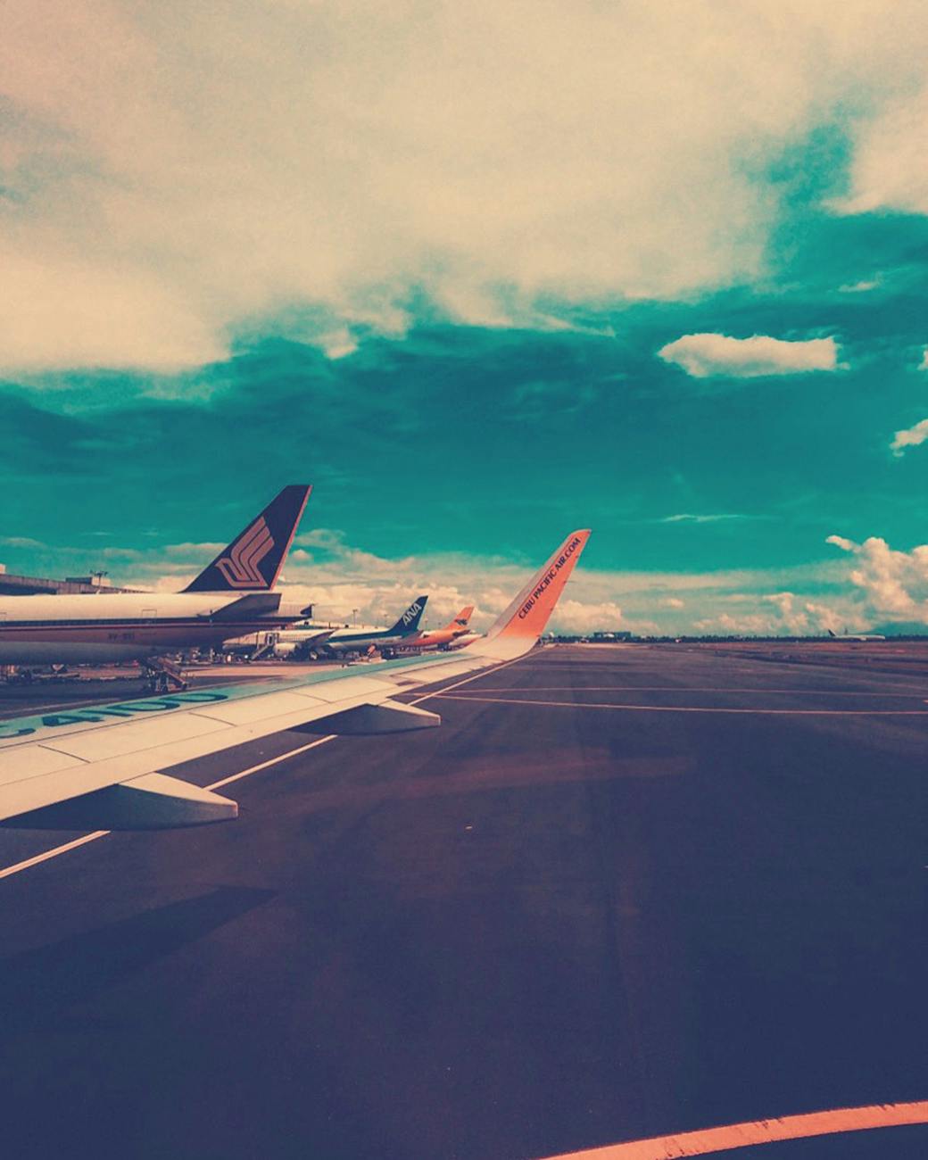 View of passenger aircraft lined up on the runway at Pasay City, Philippines.