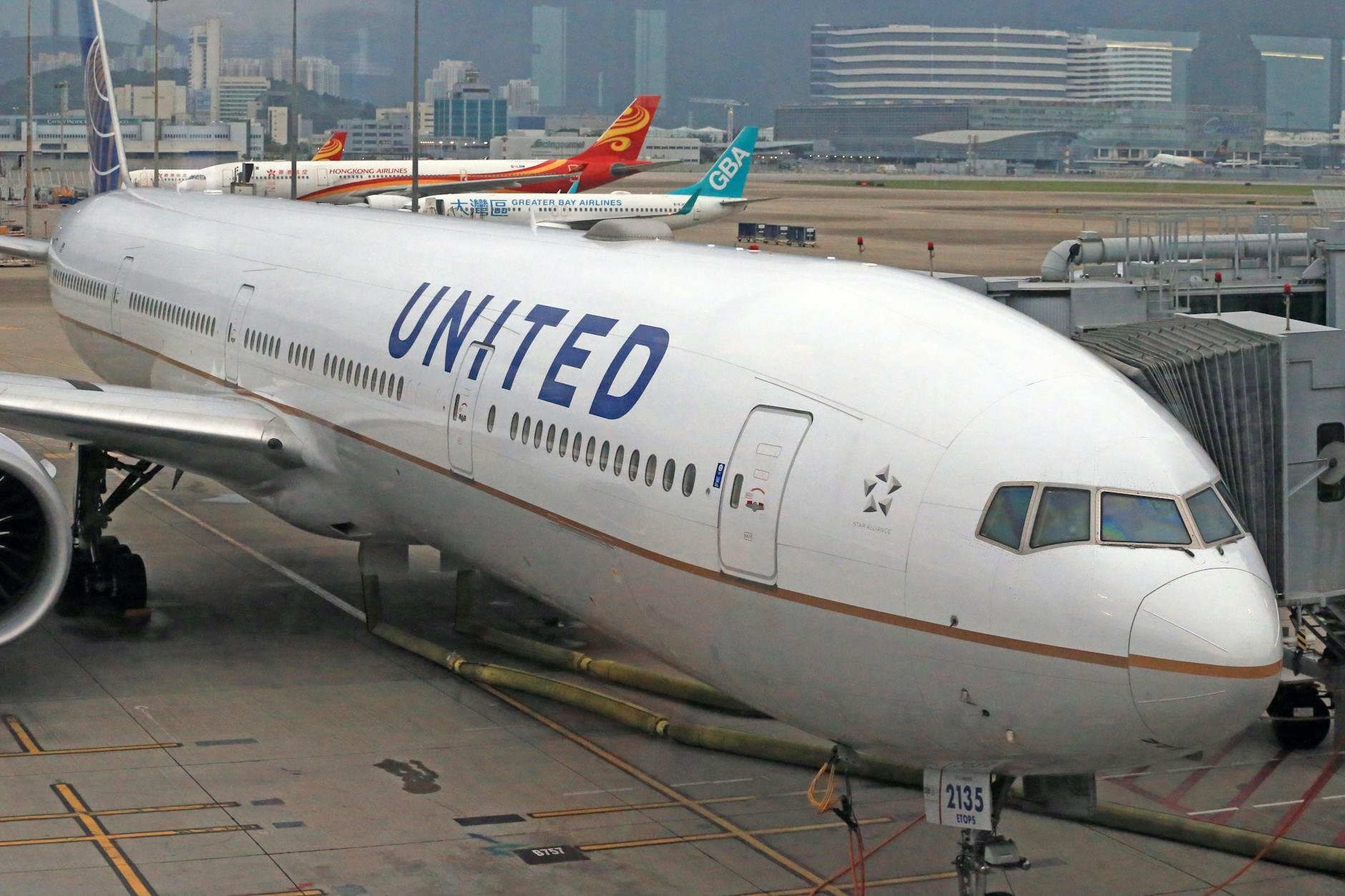 United Airlines jet parked at an airport gate, ready for boarding.