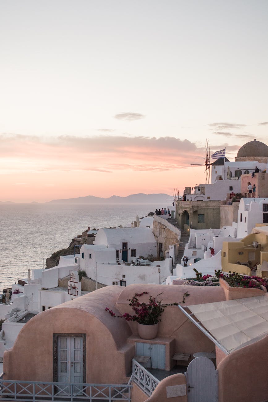 Captivating view of Santorini's iconic architecture and Aegean Sea at sunset.