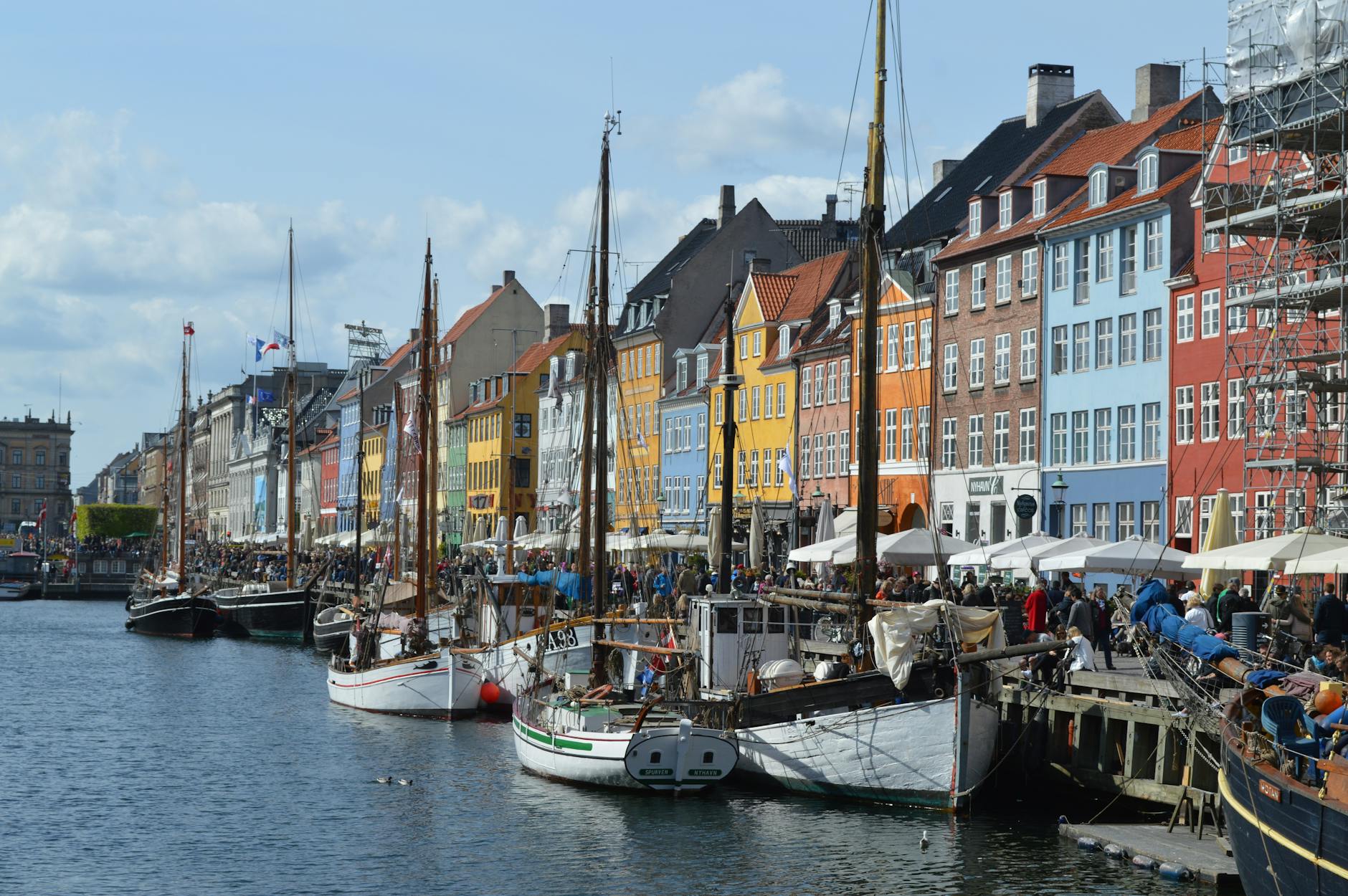 Vibrant waterfront scene of Nyhavn harbor with historic buildings and boats in Copenhagen.
