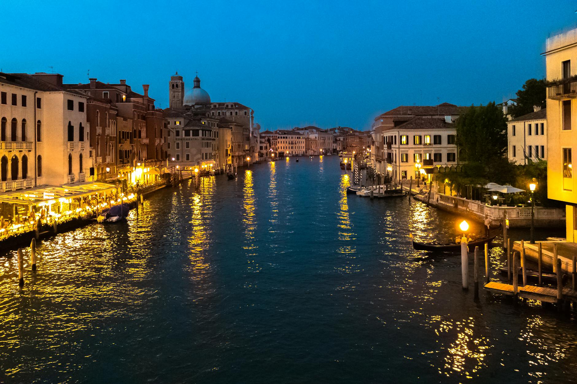 Stunning view of Venice's Grand Canal illuminated at night, capturing the historic architecture and vibrant atmosphere.
