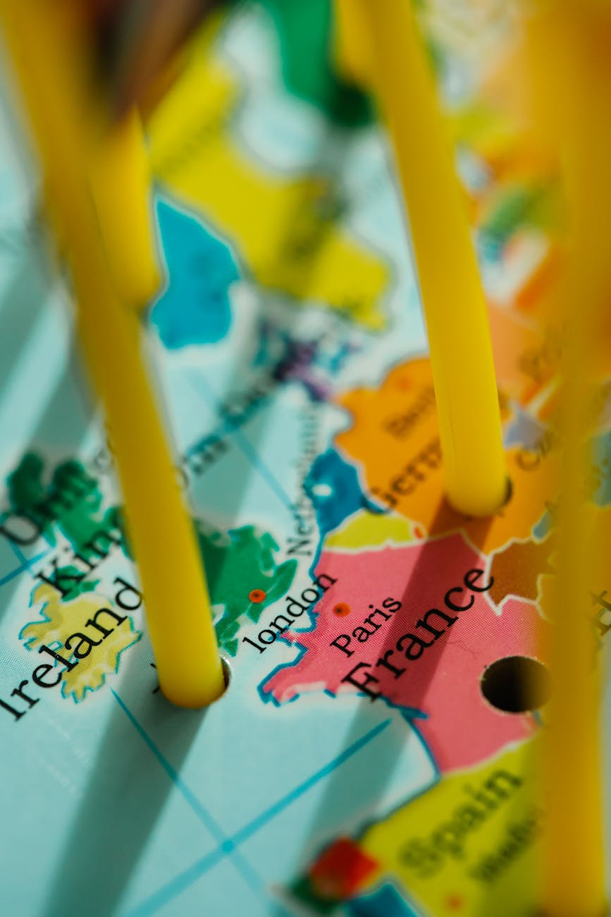 Close-up view of a Europe map with cities marked by pegs, highlighting travel destinations.