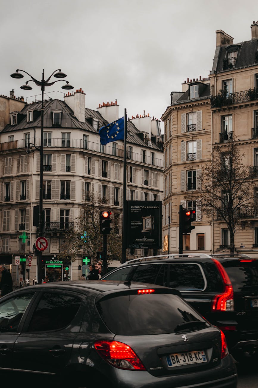 View of a bustling traffic intersection in Paris, showcasing classic French architecture.