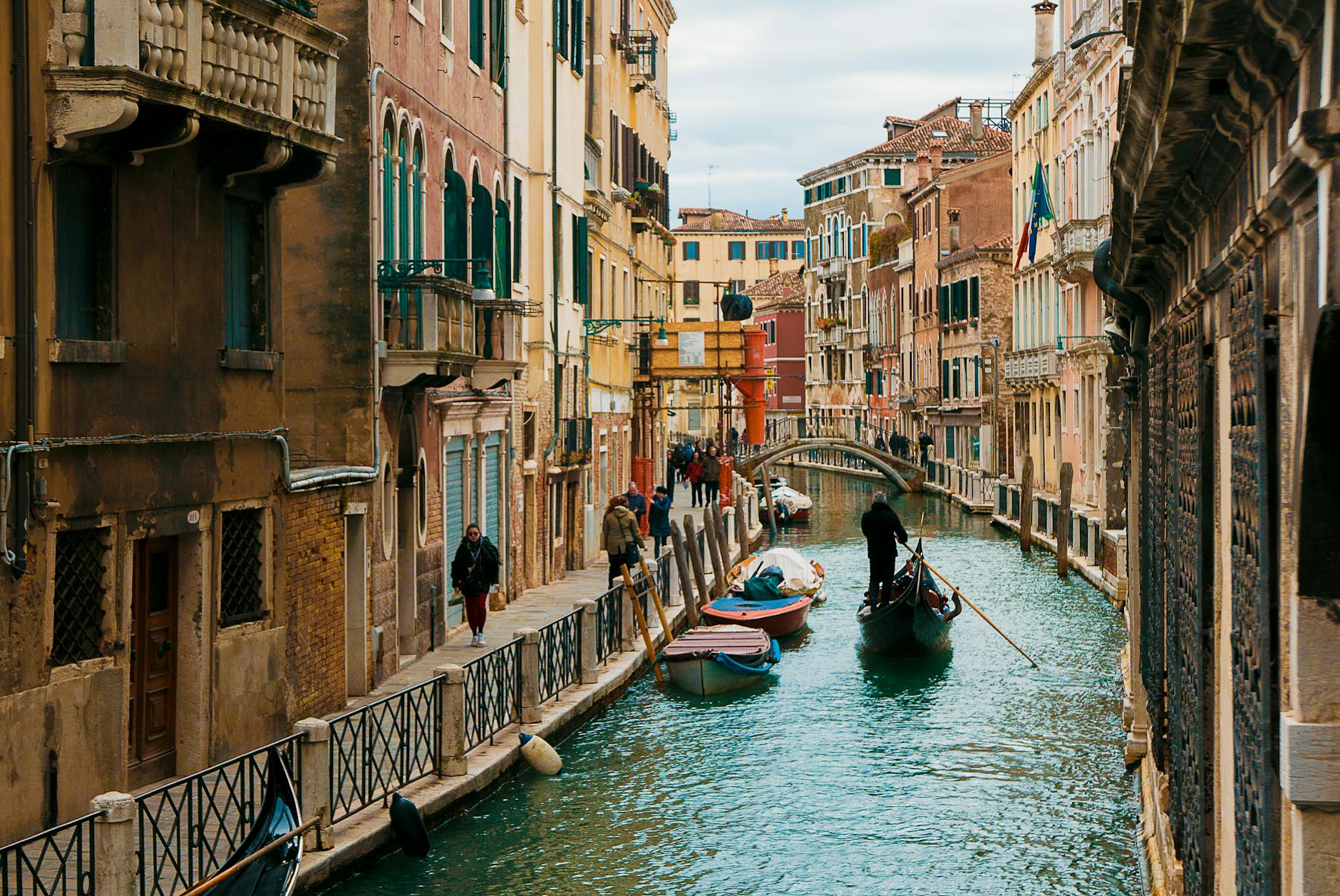 Charming view of a Venetian canal with a gondola, showcasing the architectural beauty of Venice, Italy.