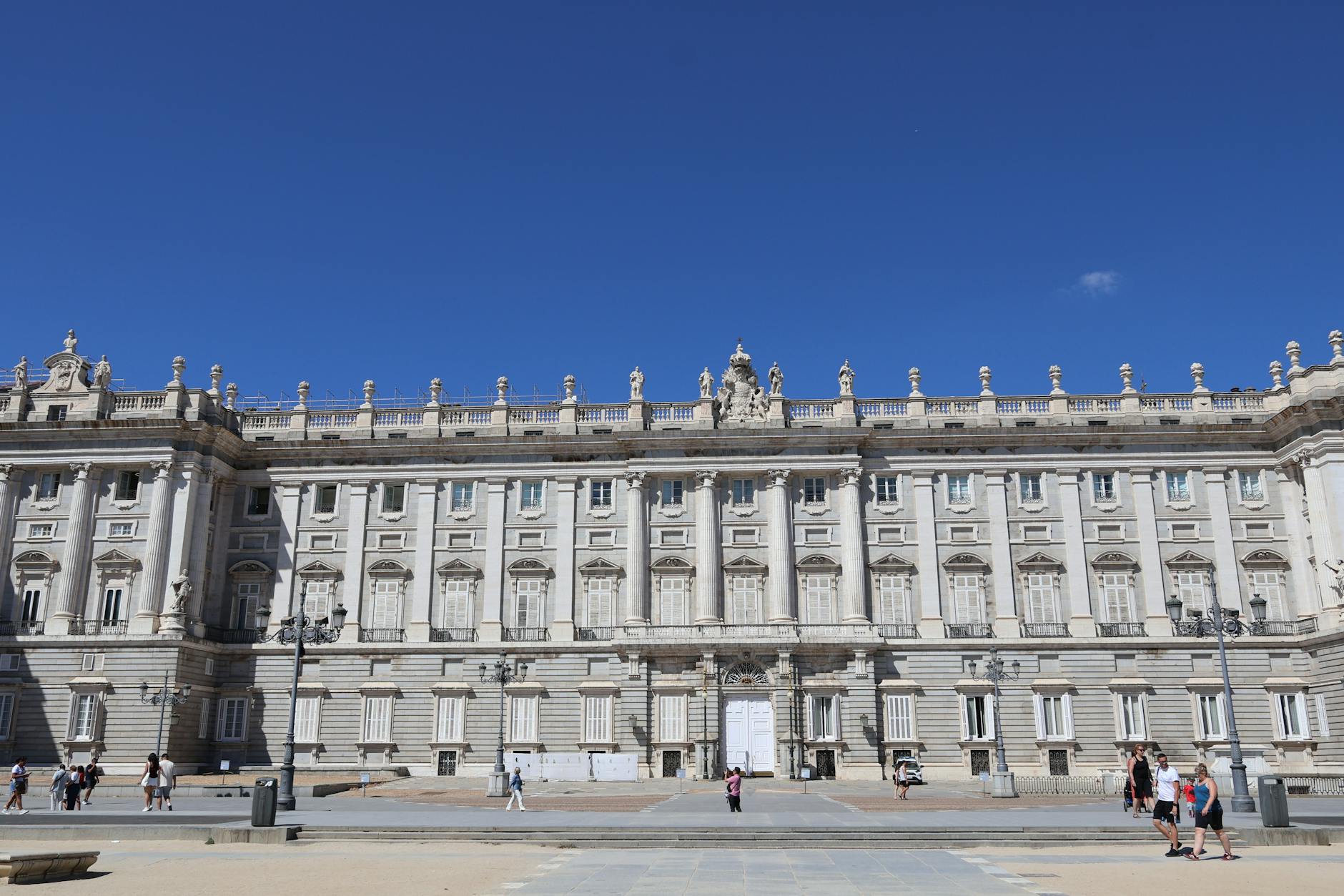 Front view of the Royal Palace of Madrid, Spain on a sunny day with clear blue skies.