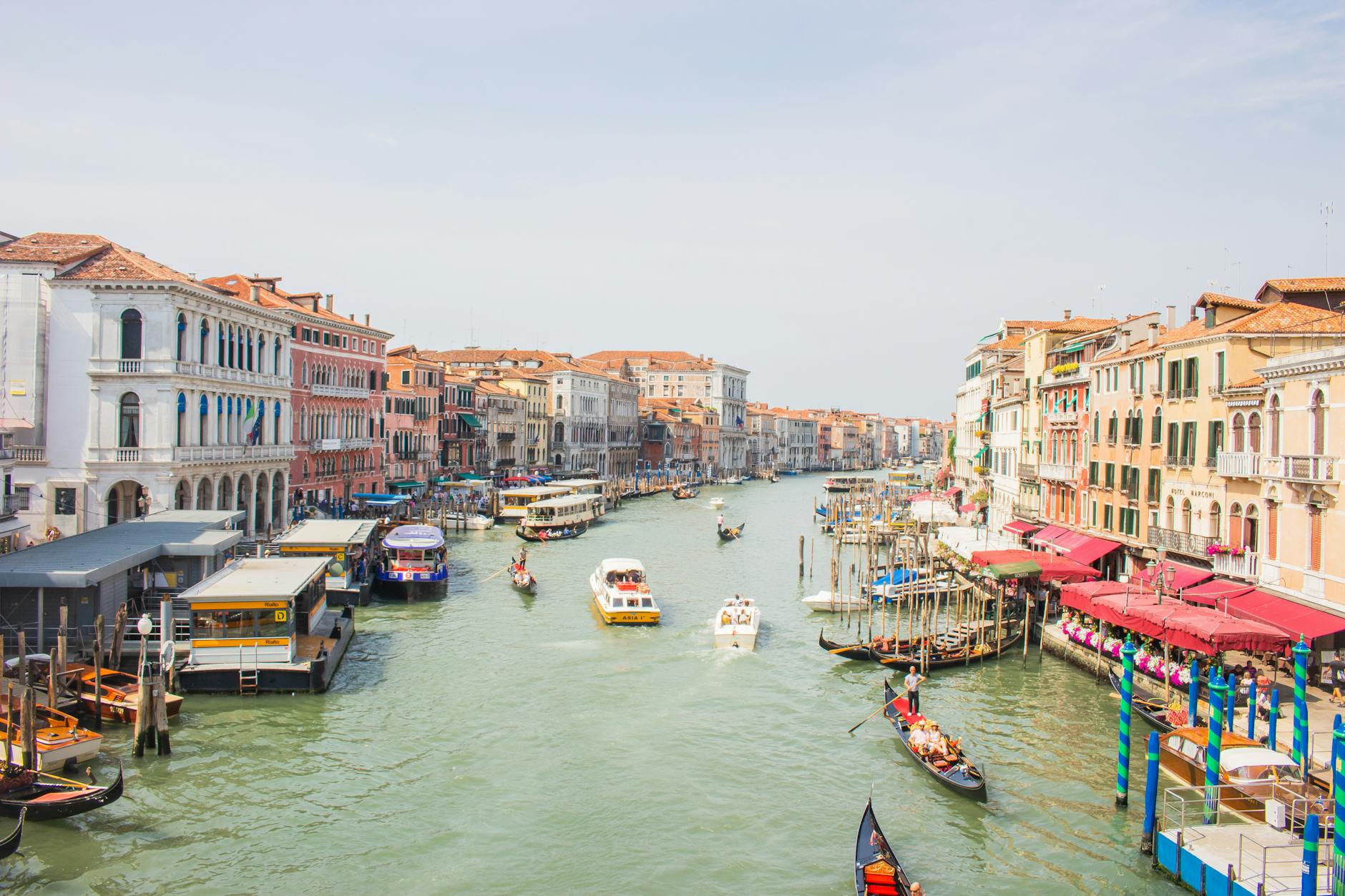 A lively view of Venice's Grand Canal featuring gondolas and historic architecture.