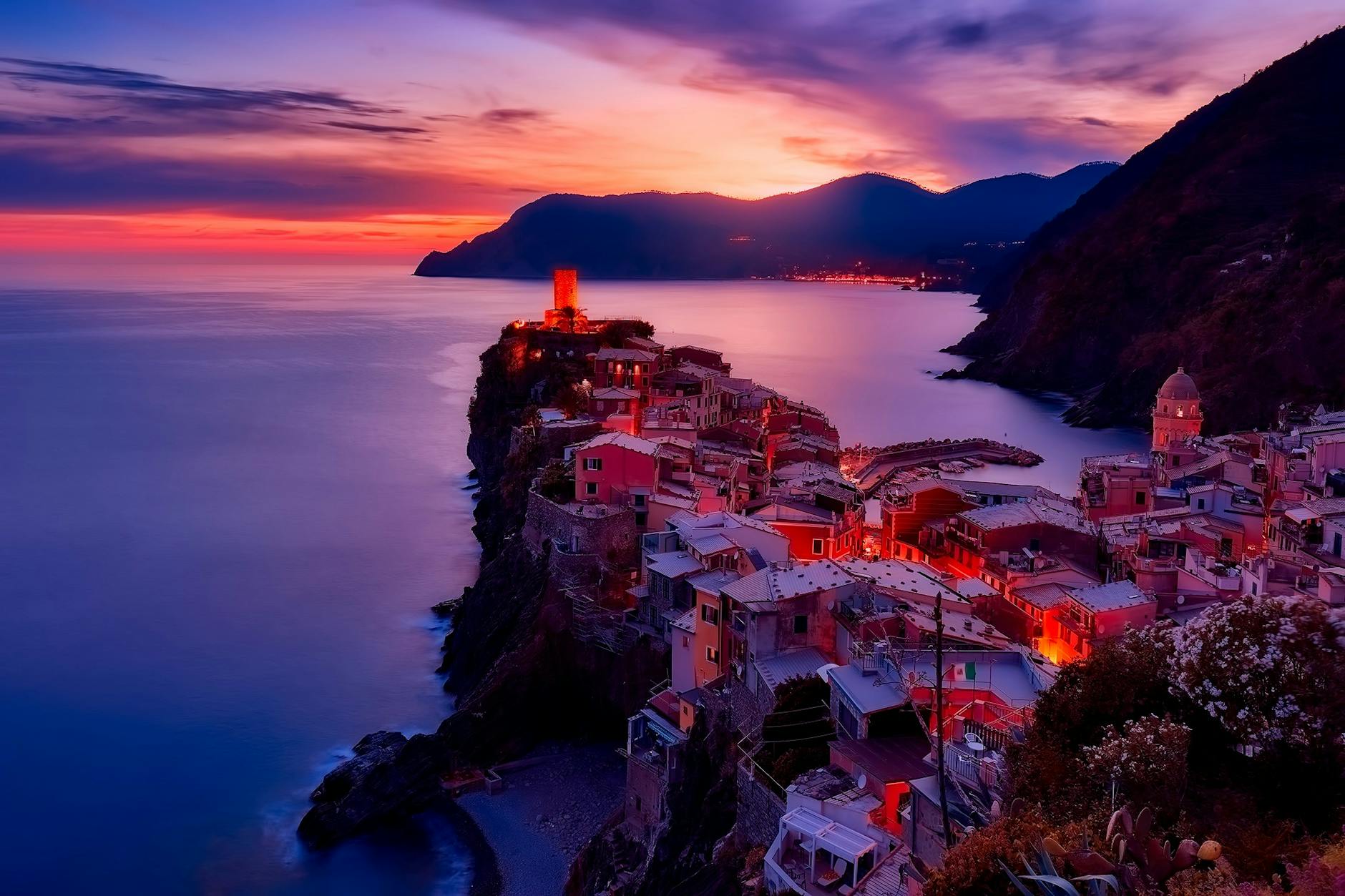 Discover the serene beauty of Vernazza during a mesmerizing sunset along Italy's Cinque Terre coast.
