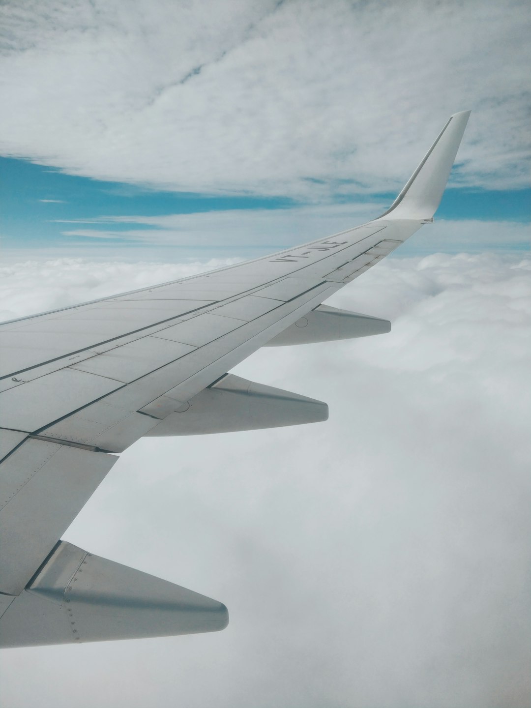 aerial photography of airplane wing and clouds